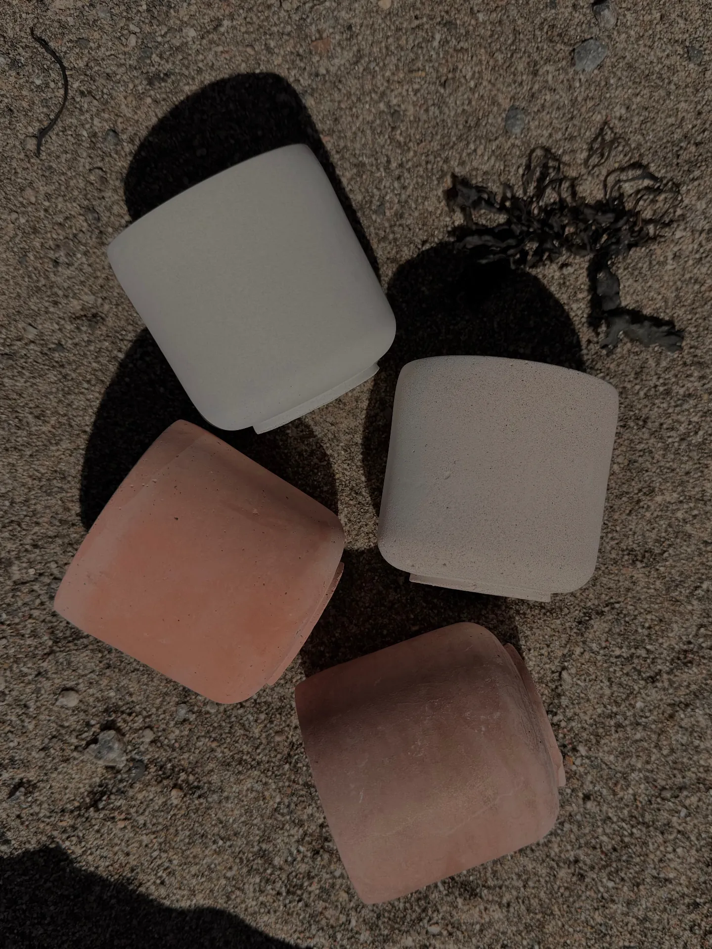 The four LUĒR candles — Sol, Aura, Lune and Ember — gathered on linen